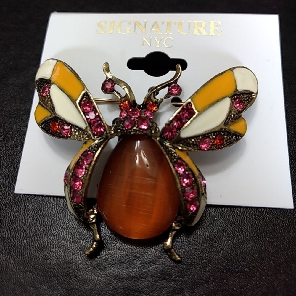 Signature NYC gold tone bug brooch